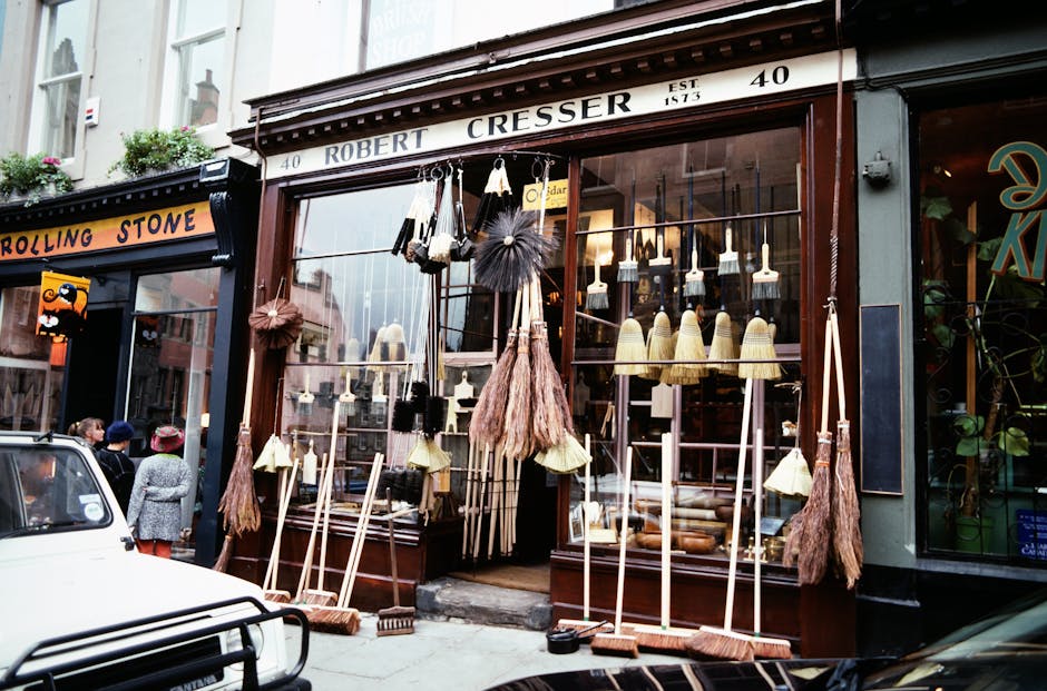 Exterior view of a fish and seafood shop named 'Camden Quality Fish' situated on a brick building, with a blue signage board displaying the shop's name and offerings. The shop features large glass win